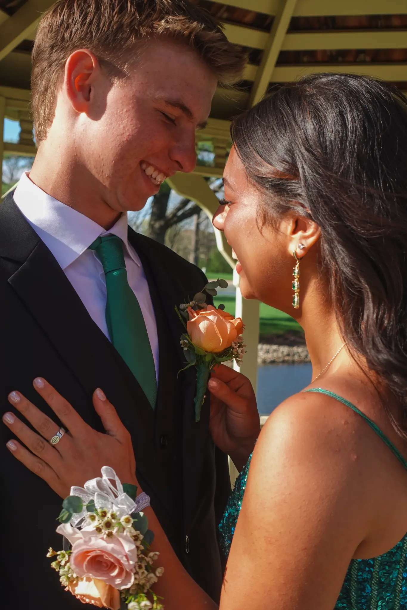 Close prom portrait of a couple smiling together with boutonniere and corsage details visible in Northwest Indiana.